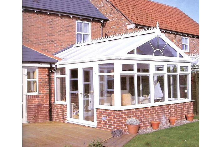 White Gable End conservatory with partial box gutter and sunburst gable front